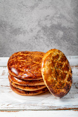 Sesame ramadan pita on a wood floor. Ramadan delicacies. Pita bread special for the month of...