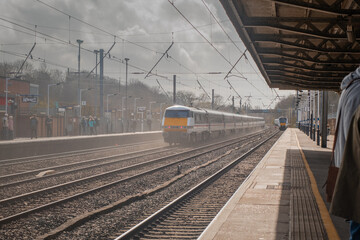 Fast and a conventional train on a Hitchin train station in england. Typical train station in...