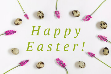 Easter composition with text Happy easter, quail eggs, fresh flowers frame. Top view, flat lay