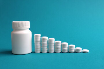 On a turquoise background, round medicine pills stand in the form of a ladder.