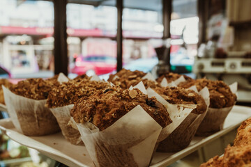 A tray of vegan muffins sitting on a cafe counter.