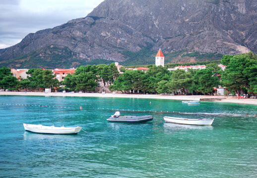 Boats at turquoise sea water .  Sandy beach and lagoon scenery . Promajna Public Beach in Croatia 