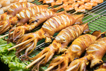 Grilled squid on skewers in the street market of Bangkok