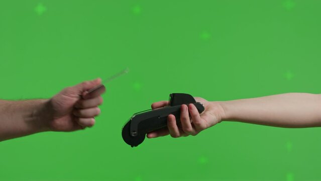 Close-up of hand hold wireless bank payment POS terminal to process acquire credit card payments on green screen background. Copy space mock up advertising