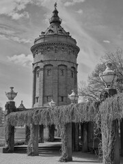Landmark of Mannheim, the water tower, photographed in black and white, background with many...