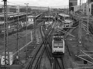 Main station of Mannheim, black and white photo, many rails and a train with freight wagons