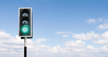 Junction traffic light with green bright open to start, running and go a head, or permit allow passing, blue sky background