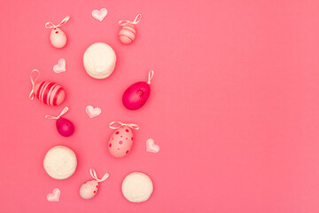 Easter eggs, small hearts and big marshmallows on pink background provide ample space for copying