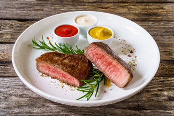 Fried beef sirloin on wooden table
