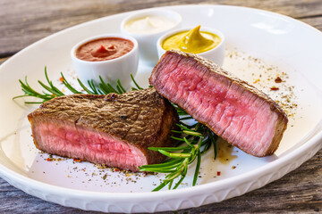 Fried beef sirloin on wooden table
