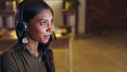 Crm, communication or friendly Indian woman consulting in call center helping, speaking or talking at customer support. Computer, night or consultant in telemarketing or telecom company with advice