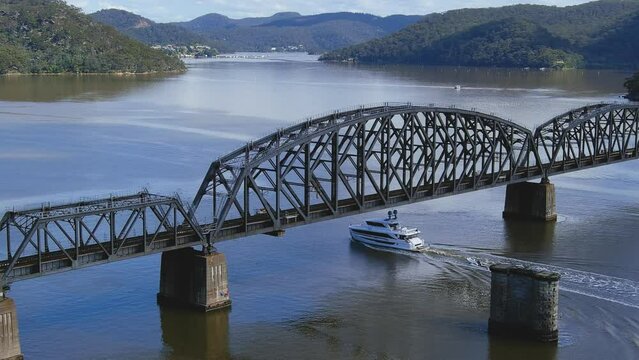 Cruiser going under bridge slowly on Hawkesbury River NSW Borooklyn extended UHD 48 sec