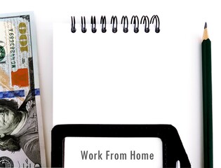 Dollars money , notebook, a pencil and ID card with text written WORK FROM HOME, concept of staff...