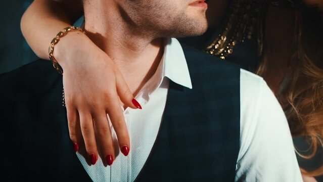 Sexy couple woman's hand seductive strokes man's neck chest close-up. Man face cropped mouth lips close. lovers adult guy and girl. girlfriend gently touches beloved boyfriend. fingers red manicure