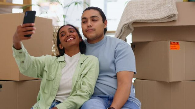 Happy couple, real estate and smile for selfie, moving or social media relaxing on floor in new home. Man and woman smiling for photo, house loan or mortgage and relocating in property boxes together