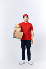 Young man holding delivery package looking positive and happy standing and smiling