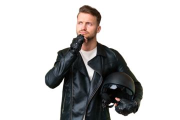 Young caucasian man with a motorcycle helmet over isolated chroma key background and looking up