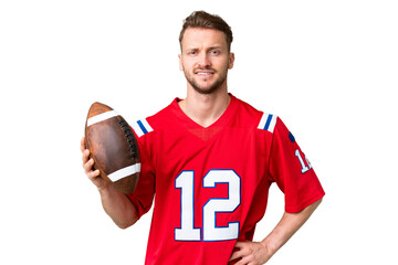 Young caucasian man playing rugby over isolated chroma key background posing with arms at hip and smiling