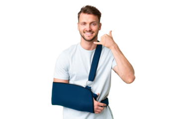 Young caucasian man with broken arm and wearing a sling over isolated chroma key background making phone gesture. Call me back sign