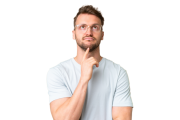 Young handsome caucasian man over isolated chroma key background With glasses and looking up