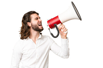 Young handsome man over isolated chroma key background shouting through a megaphone to announce something in lateral position
