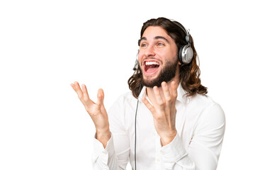 Telemarketer man working with a headset over isolated chroma key background with surprise facial expression