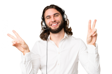 Telemarketer man working with a headset over isolated chroma key background showing victory sign with both hands