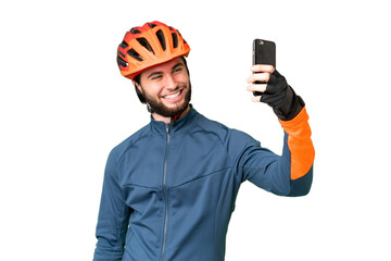Young cyclist man over isolated chroma key background making a selfie - obrazy, fototapety, plakaty