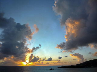 Breathtaking sunrise sunset dusk dawn twilight scenery over ocean with silhouettes of people and boats yachts seen panoramic view from cruiseship cruise ship liner during Caribbean cruising