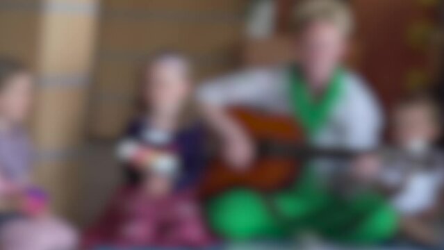 group of mothers singing and dancing with children defocused