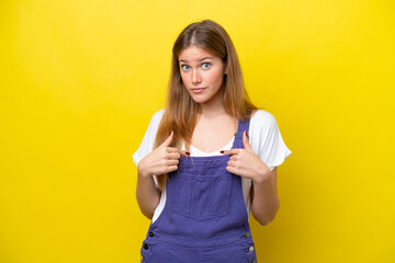 Young caucasian woman isolated on yellow background pointing to oneself