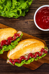 Hot dogs, coleslaw and ketchup on wooden table
