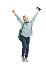 excited Muslim female college student raises hand holding up smartphone on white background