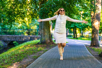 Beautiful woman walking in city park
