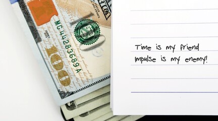 cash dollar money with text written TIME IS MY FRIEND , IMPULSE IS MY ENEMY - to remind oneself a...