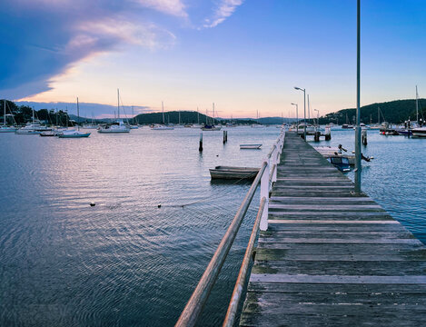 Seascape perspective at sunset in the small resort town of Killcare with the pier and marina in the foreground on the Central Coast, NSW, Australia.