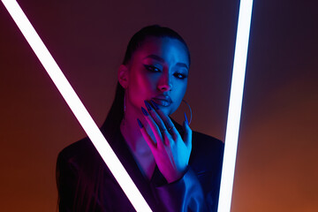 beautiful young woman in color lights. Brunette girl with long Nails