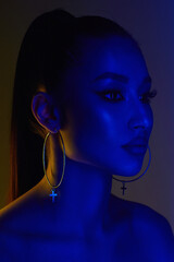 beautiful young woman in color lights