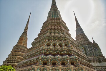 Beautifully detailed towers with many ornaments at Wat Pho temple in Bangok in Thailand.