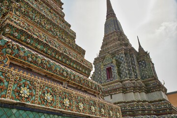Beautifully detailed towers with many ornaments at Wat Pho temple in Bangok in Thailand.