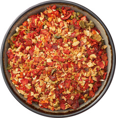 Bowl of spice mix for cooking dishes, isolated on white. Flakes of red hot pepper, paprika, garlic, onion. Dried seasoning closeup. Top view.