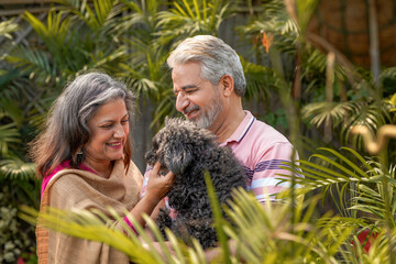 Senior couple loving with dogy puppy. concept about pets and animals.
