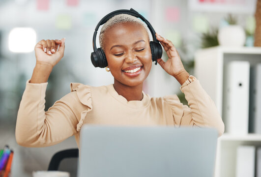 Dance, happy and black woman with music in office, radio break and listening to audio. Smile, enjoying and dancing African employee with headphones for streaming a podcast, songs and playlist
