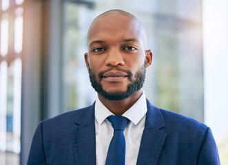 Business man, portrait and corporate lawyer in a office with success and company ideas. Law, management and African ceo worker face of legal job growth with lens flare and blurred background