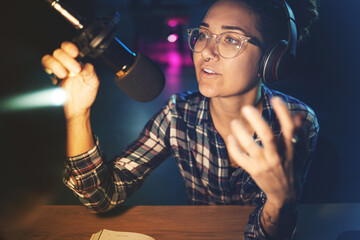 Podcast, microphone and live streaming woman speaking, advice or broadcast on gen z platform at...