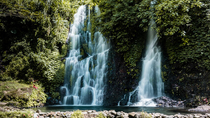 Beautiful wild waterfalls (Jagir Waterfall) in the jungle on the slopes of Kawah Ijen volcano,...