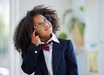 Thinking, smile and a girl dressed as an employee with a plan, idea or strategy in an office. Happy, cute and a little child playing pretend in business with a solution, thoughtful and ideas
