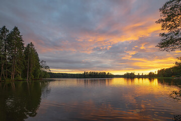 The perfect time for fishing.Sunset on a forest lake is reflected in the mirrored water.A cool place for a fisherman.Sunset on the Karelian isthmus.
