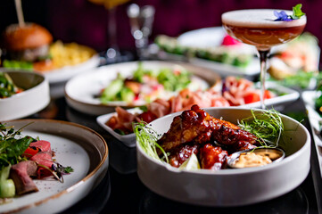table full of delicious food in plates in restaurant