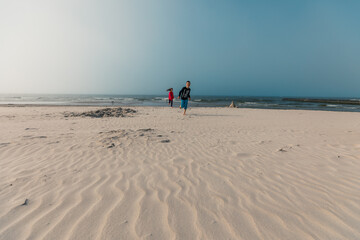 Kids having fun on beautiful sandy beach at Baltic Sea, Poland